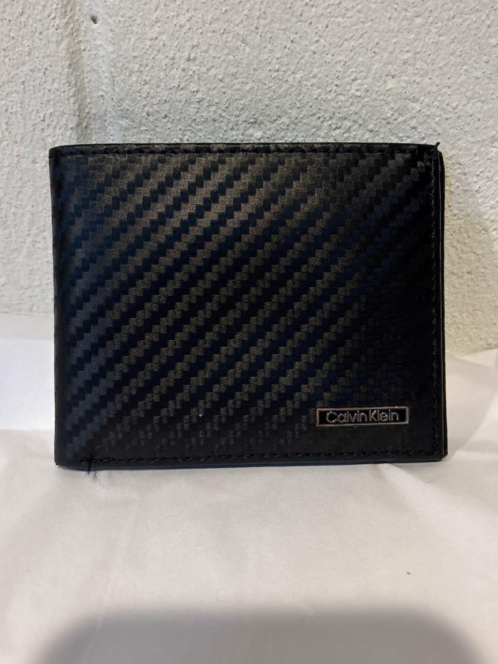 Calvin Klein men’s black leather bifold wallet textured front